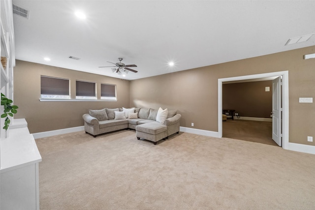 living room featuring recessed lighting, baseboards, visible vents, and light colored carpet