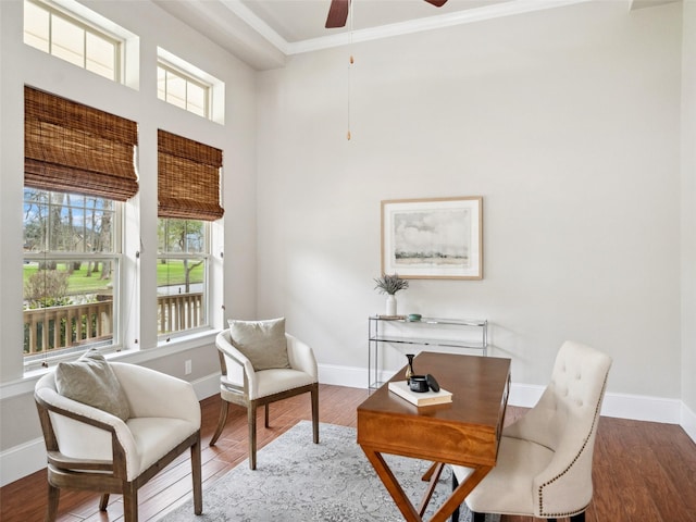 sitting room with ceiling fan, ornamental molding, wood finished floors, and baseboards