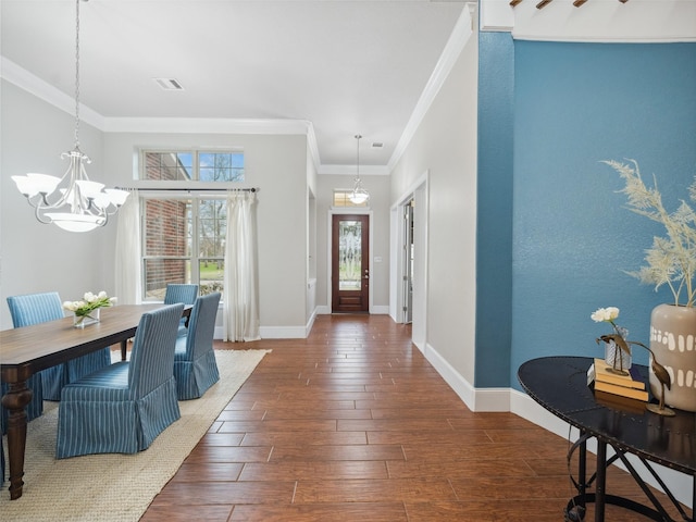 entrance foyer with baseboards, an inviting chandelier, dark wood finished floors, and crown molding