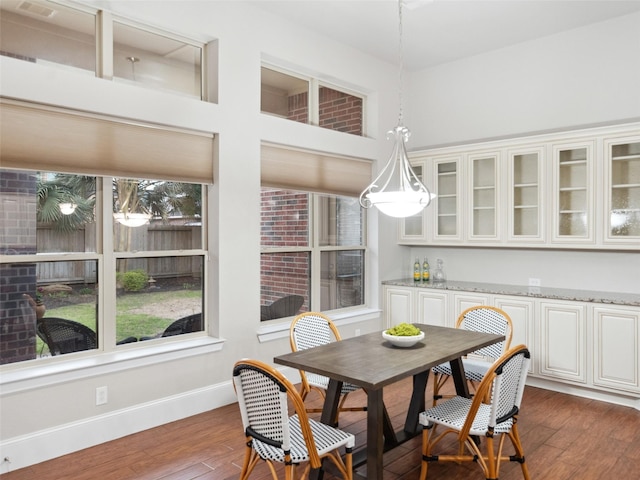 dining room featuring baseboards and dark wood-style flooring