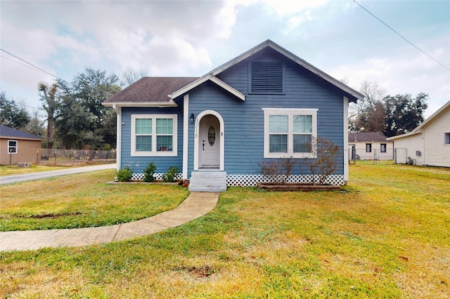 bungalow-style home featuring a front yard