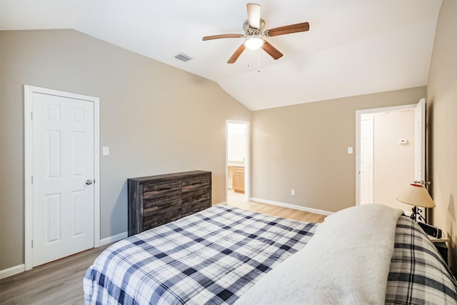 bedroom featuring ceiling fan, lofted ceiling, and light wood-type flooring