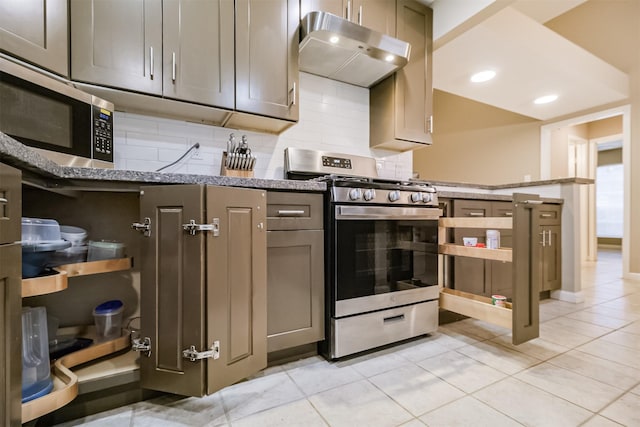 kitchen featuring light tile patterned flooring, appliances with stainless steel finishes, light stone countertops, and backsplash