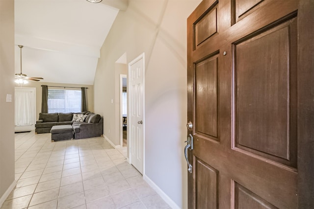 entryway with vaulted ceiling, light tile patterned flooring, and ceiling fan