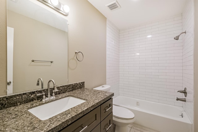 full bathroom featuring vanity, tiled shower / bath combo, and toilet