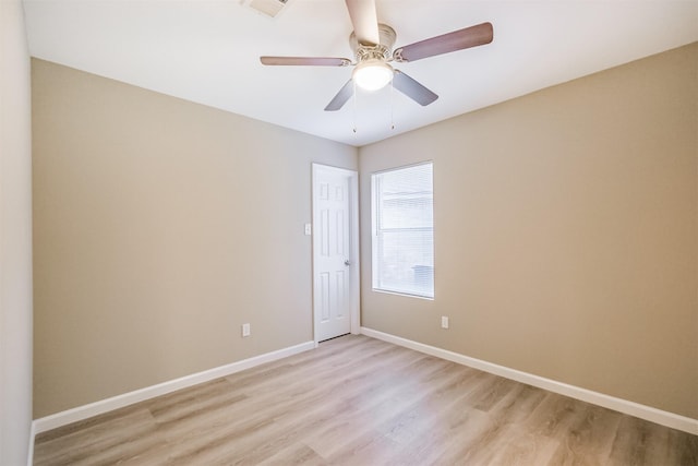 empty room with ceiling fan and light wood-type flooring