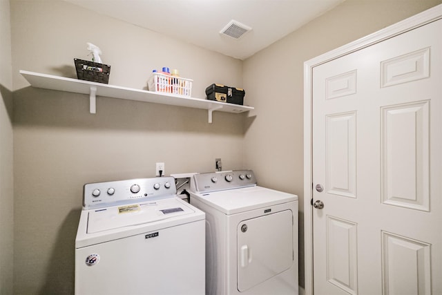 laundry room featuring washing machine and dryer