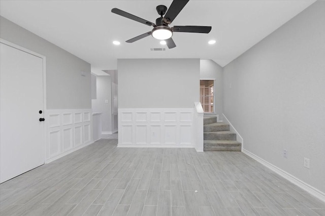 unfurnished living room featuring ceiling fan and light hardwood / wood-style floors