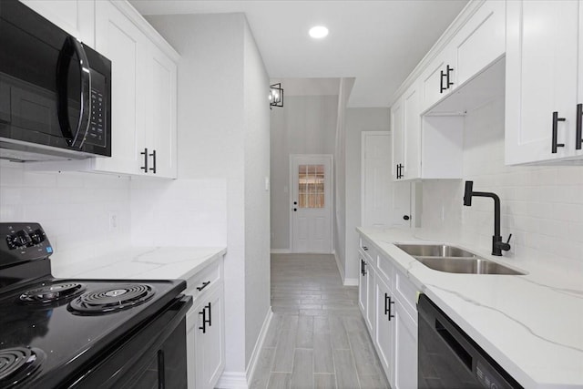 kitchen featuring white cabinets, light stone countertops, sink, and black appliances