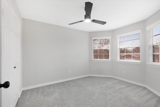 empty room with ceiling fan and light colored carpet