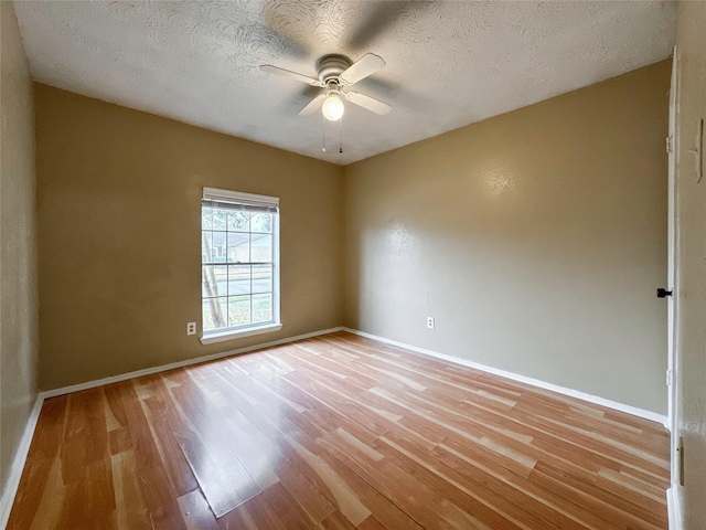 empty room featuring a textured ceiling, ceiling fan, and light hardwood / wood-style flooring