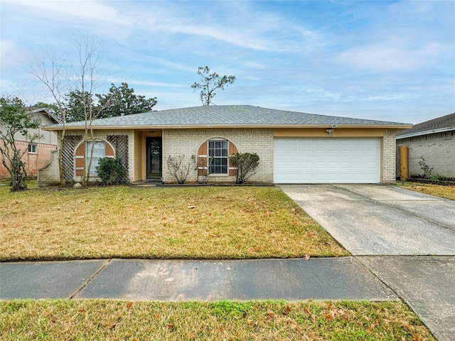 ranch-style house featuring a garage and a front lawn