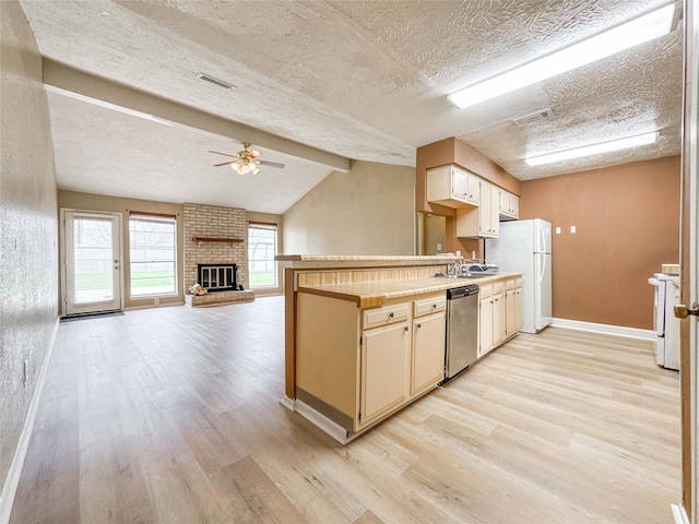 kitchen with lofted ceiling with beams, light countertops, white appliances, and light wood-type flooring