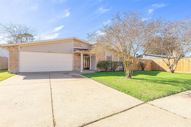 single story home featuring a garage and a front yard