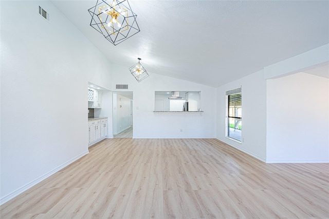 unfurnished living room with light hardwood / wood-style flooring and vaulted ceiling