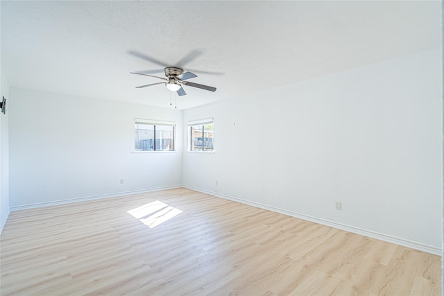 unfurnished room with a textured ceiling, ceiling fan, and light wood-type flooring