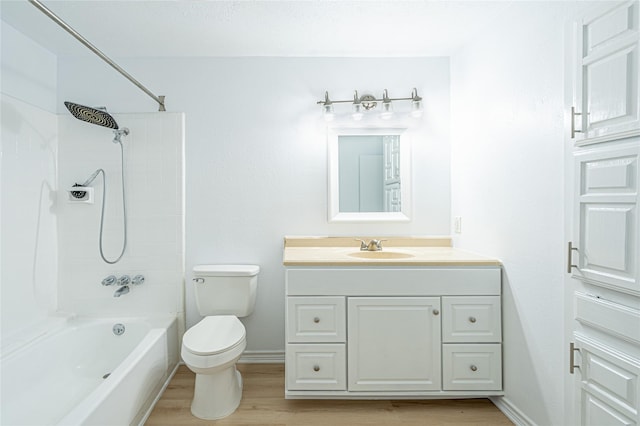 full bathroom with hardwood / wood-style flooring, toilet, vanity, and shower / bathing tub combination