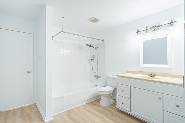 full bathroom featuring wood-type flooring, vanity, shower / bathtub combination, and toilet