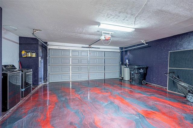 garage featuring washing machine and clothes dryer and a garage door opener