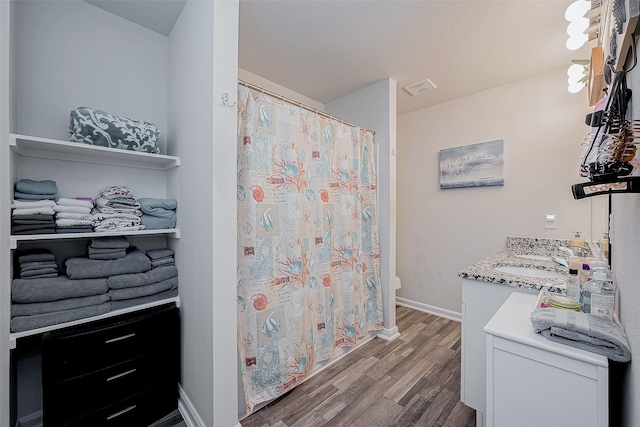 bathroom with vanity, wood-type flooring, and toilet