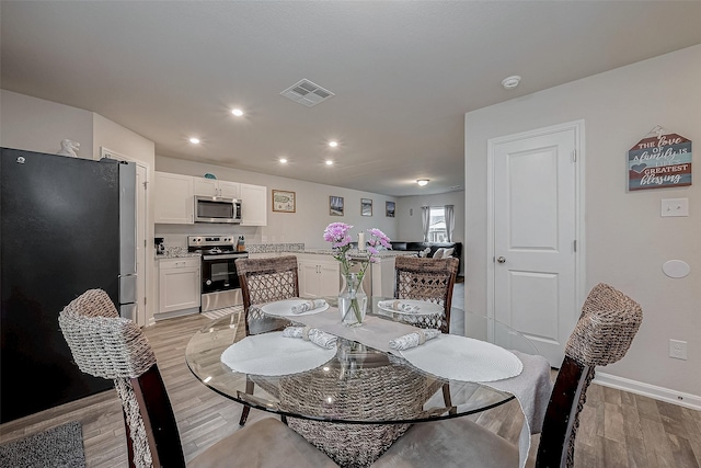 dining room with light wood-type flooring