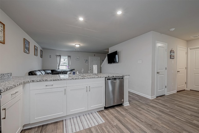 kitchen with white cabinets, light stone countertops, light hardwood / wood-style floors, and dishwasher