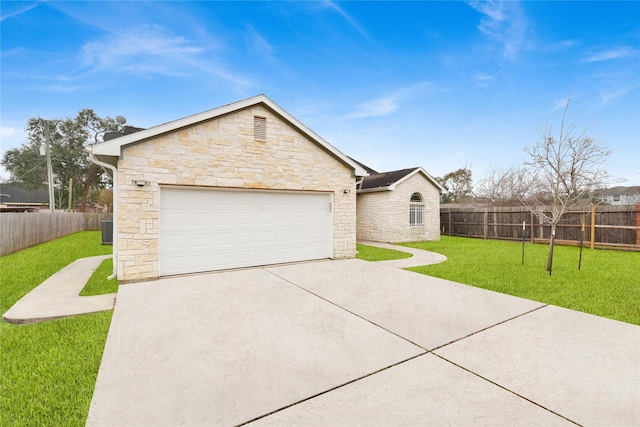 ranch-style home with a garage, a front yard, and central AC unit