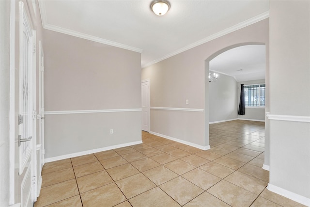 spare room featuring ornamental molding and light tile patterned floors