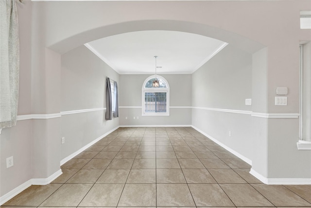 unfurnished room featuring crown molding and light tile patterned floors