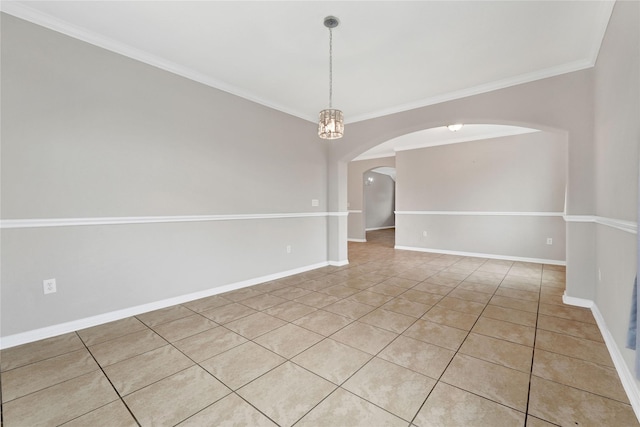 tiled empty room featuring crown molding