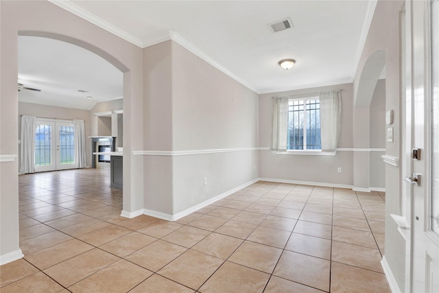 unfurnished room featuring french doors, ornamental molding, and light tile patterned floors