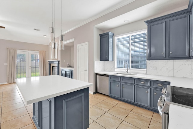 kitchen with a kitchen island, decorative light fixtures, sink, decorative backsplash, and stainless steel appliances