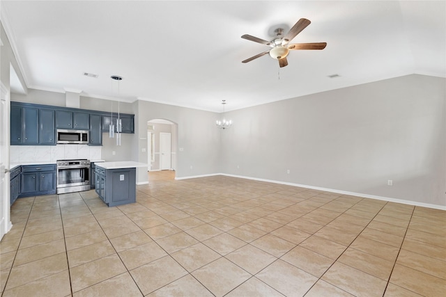 kitchen featuring blue cabinetry, crown molding, decorative light fixtures, appliances with stainless steel finishes, and ceiling fan with notable chandelier