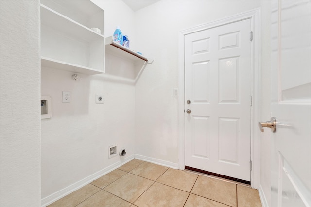 clothes washing area featuring light tile patterned flooring and electric dryer hookup