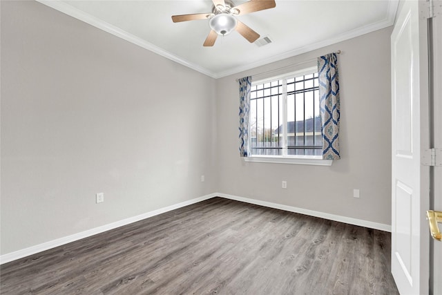 empty room with hardwood / wood-style flooring, ornamental molding, and ceiling fan