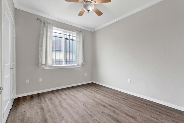 spare room with crown molding, hardwood / wood-style floors, and ceiling fan