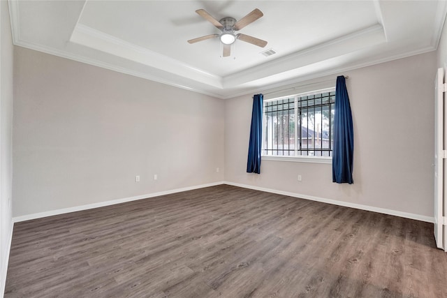 unfurnished room featuring wood-type flooring, crown molding, ceiling fan, and a tray ceiling