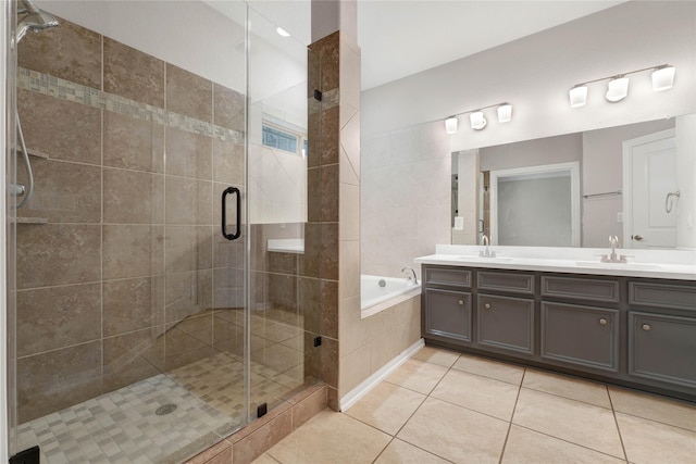 bathroom featuring tile patterned floors, independent shower and bath, and vanity