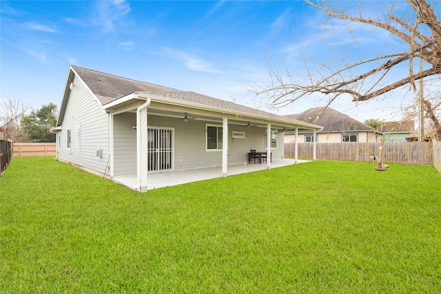 back of property with a yard and a patio