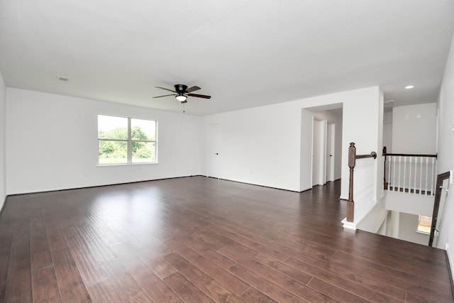 empty room featuring dark wood-type flooring and ceiling fan