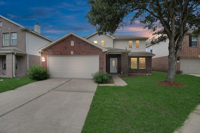 front of property featuring a garage and a yard