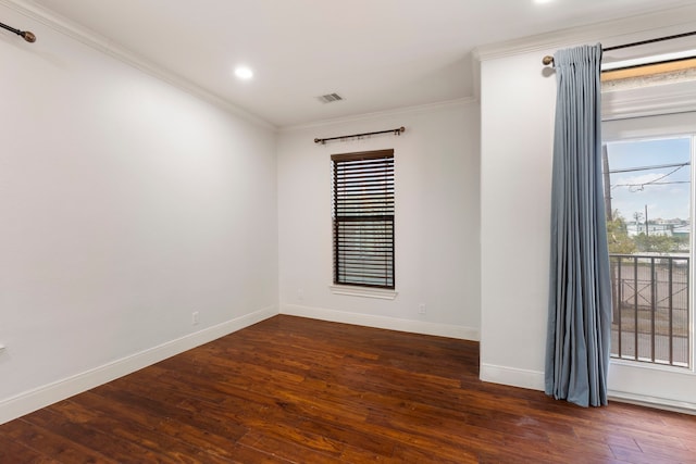 spare room with crown molding and dark hardwood / wood-style floors