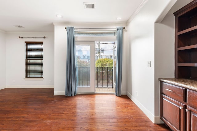 interior space featuring dark wood-type flooring and ornamental molding