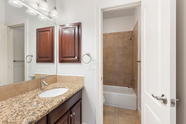 bathroom featuring tile patterned flooring, vanity, and tiled shower / bath