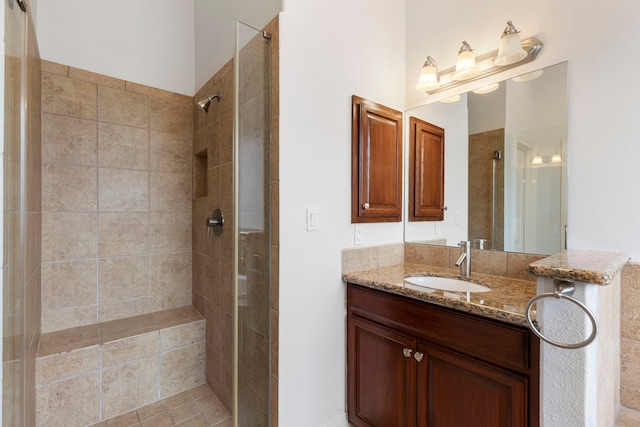 bathroom with vanity and tiled shower