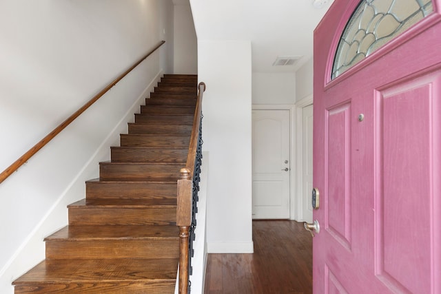 stairway featuring wood-type flooring