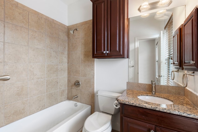 full bathroom featuring vanity, toilet, and tiled shower / bath combo