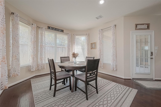 dining room with dark wood-type flooring