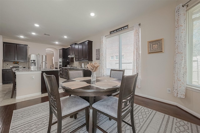 dining room featuring hardwood / wood-style flooring and sink