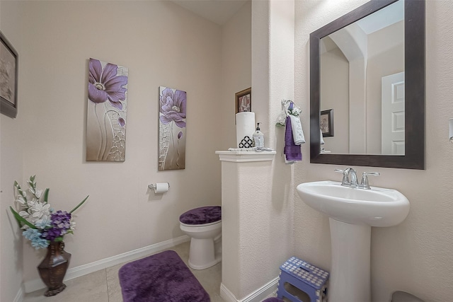 bathroom featuring tile patterned floors, toilet, and sink